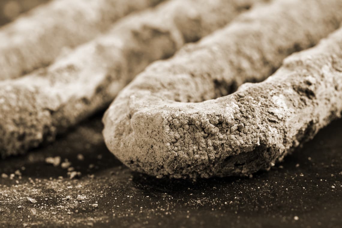 Close-up of a heating element heavily coated in hard limescale deposits